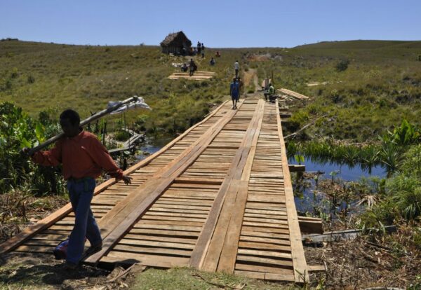 People walking across bridge