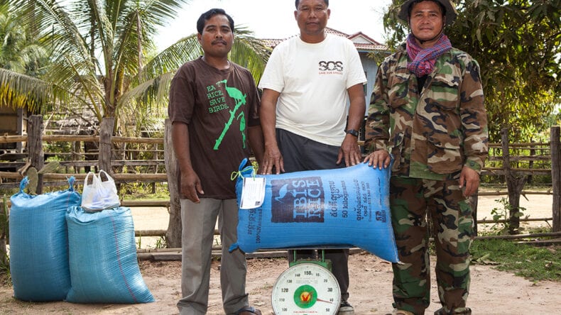 Sustainable Livelihoods: a Transformation, Not an Add-On 1 Three local men holding a bag of rice