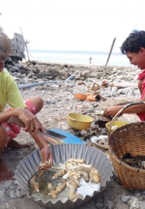 Women sorting fish in the Philippines